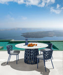 Swipe Round Dining Table by Talenti, outdoor setting