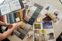 Interior designer reviewing fabric, wood, and material samples